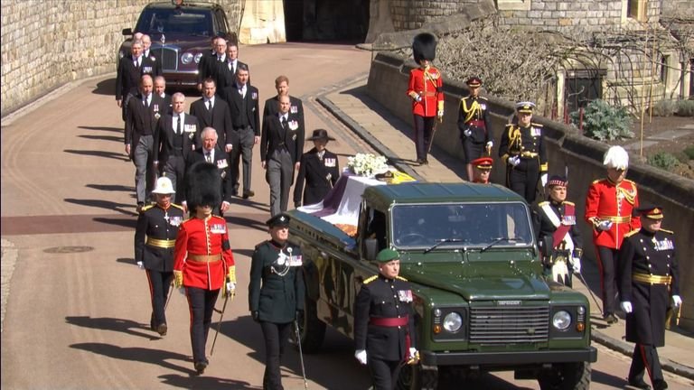 The royal family walks behind the coffin