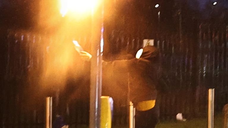 A youngster throws a petrol bomb at some traffic lights on Springfield Road, during further unrest in Belfast.  Photo date: Thursday, April 8, 2021.