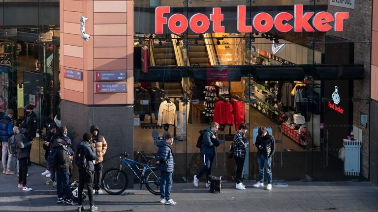 People line up outside a store in Liverpool, England on Monday April 12, 2021, before it reopens.  Pic: AP