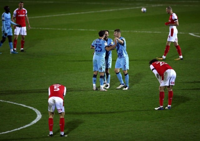 Coventry City's Matty James, Liam Kelly and Kyle McFadzean (left-right) celebrate after the final whistle as the Rotherham United players look dejected.  Photo: Tim Goode / PA Wire.