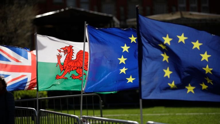 A Welsh flag, second from left, placed by protesters supporting Britain's retention in the European Union is blown in the wind alongside a Union flag, on the left, and two European flags near of the Houses of Parliament in London, Tuesday March 5, 2019 The National Assembly for Wales and the Scottish Parliament are both due to vote on motions on Tuesday declaring their opposition to British Prime Minister Theresa May's Brexit deal and declaring their opposition to a no-deal Brexit.  (AP Photo / Matt Dunham)