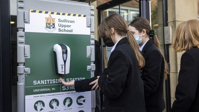 Students use a hand sanitizer station at Sullivan High School in Holywood