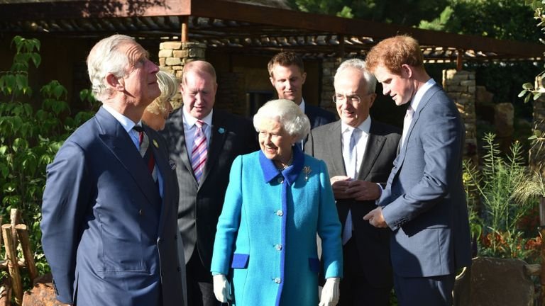 The Prince of Wales (left), Queen Elizabeth II and Prince Harry (right), in Sentebale Garden, with Philip Green (second from right) and David Brownlow (third from left), who are the main supporters of the Lesotho Sentabale Charity and Chelsea Garden and the Garden's designer Matt Keightlry (rear) at the annual Chelsea Flower Show at the Royal Hospital Chelsea in London.