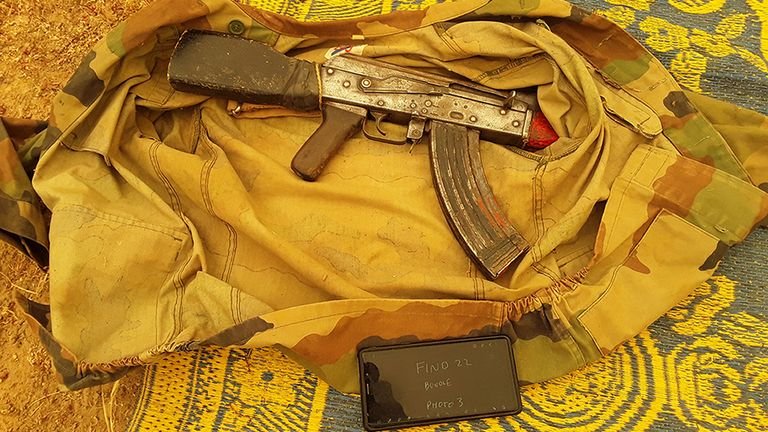 AK47 rifles, hundreds of cartridges, camouflage clothing, radios, cell phones and hundreds of gallons of fuel were found