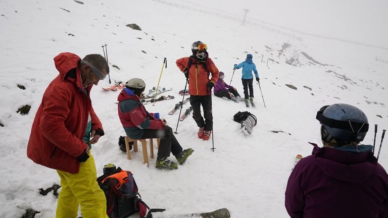 Skiers take a rest during heavy snowfall at the Lake District Ski Club