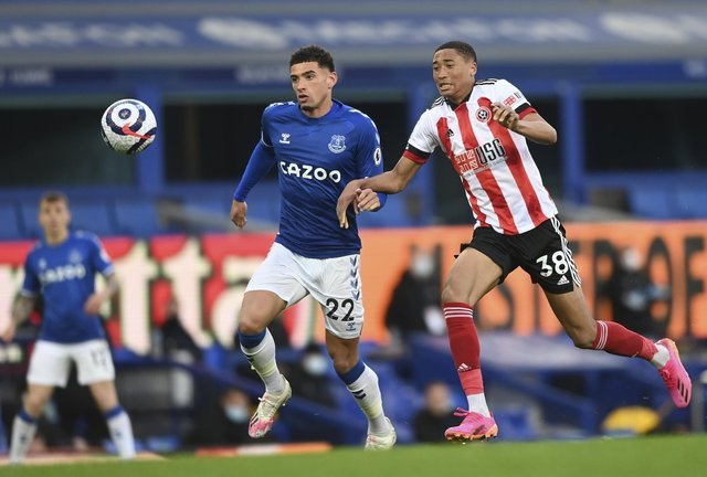 Ben Godfrey of Everton, left, and Daniel Jebbison of Sheffield United challenge the ball during the English Premier League soccer match between Everton and Sheffield United at Goodison Park in Liverpool, England on Sunday 16 May 2021 (Credit: Gareth Copley / Pool via AP)