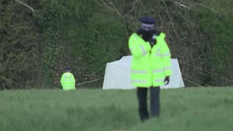 A forensic tent has been set up in a field