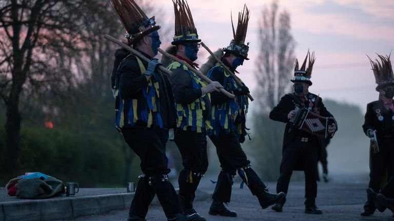 Members of the Hook Eagle Morris Men perform outside the Shack Cafe near Hook in Hampshire as they see it at dawn on May 1st.  This is the first time they have been able to perform together since January 2020 and it is the first time they have performed in their new blue face paint.  Photo date: Saturday, May 1, 2021.