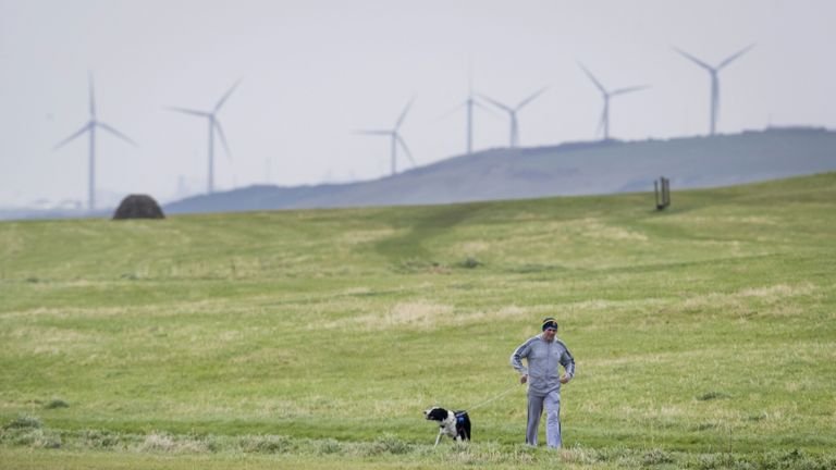 File photo dated 15/10/17 of a man walking his dog near Whitehaven in Cumbria.  Plans approved for a new coal mine near the city of Cumbria will produce more emissions than any others currently open in the UK, a climate group has warned.  Issue date: Saturday, January 30, 2021.