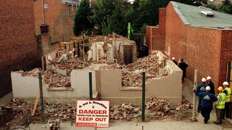Workers watch 25 Cromwell Street Gloucester, the former home of serial killers Fred and Rosemary West, demolished on October 11.