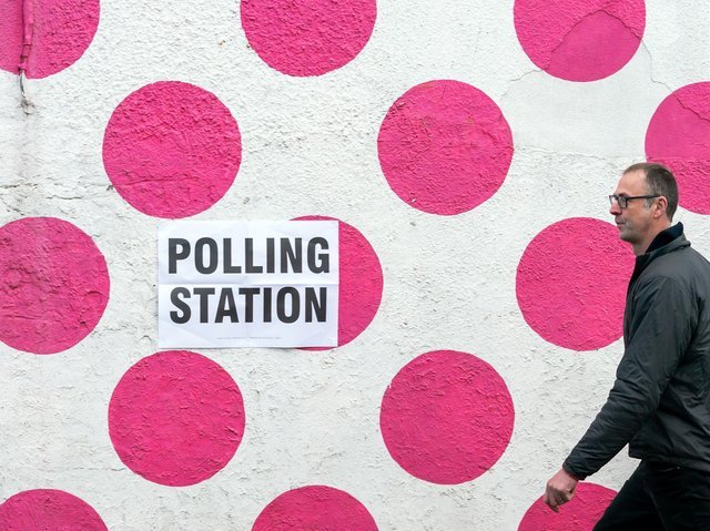 A man passes a polling station at the Bank View Cafe, Sheffield