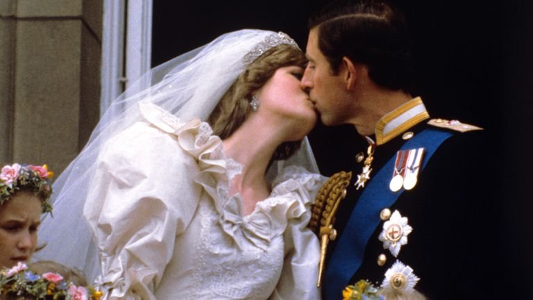 File photo dated 29/07/81 of the newly married Prince and Princess of Wales kissing on the balcony of Buckingham Palace after their wedding ceremony at St Paul's Cathedral.  The famous wedding dress of Diana, Princess of Wales, will be on display at Kensington Palace for the first time in 25 years.  Issue date: Monday April 26, 2021.