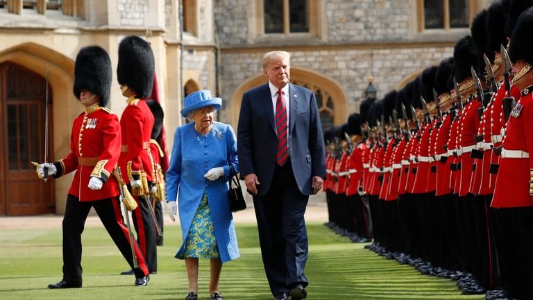 FILE - In this file photo from Friday, July 13, 2018, US President Donald Trump and British Queen Elizabeth inspect the guard of honor at Windsor Castle in Windsor, England.  US President Donald Trump will pay a state visit to Britain in June as a guest of Queen Elizabeth II, Buckingham Palace announced on Tuesday, April 23, 2019. The palace said Trump and his wife, Melania, had accepted an invitation from the Queen for a visit which will take place from June 3 to 5.  (AP Photo / Pablo Martinez Monsivais, file)