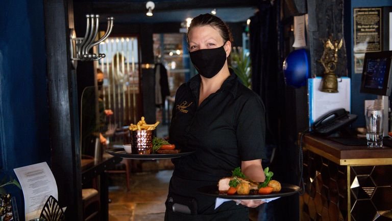 A waitress carries meals to a table during service at Loxleys Restaurant & Wine Bar in Stratford, Warwickshire, as indoor hospitality and entertainment venues reopen to the public following the further easing of lockdown restrictions in England .  Picture date: Monday May 17, 2021.