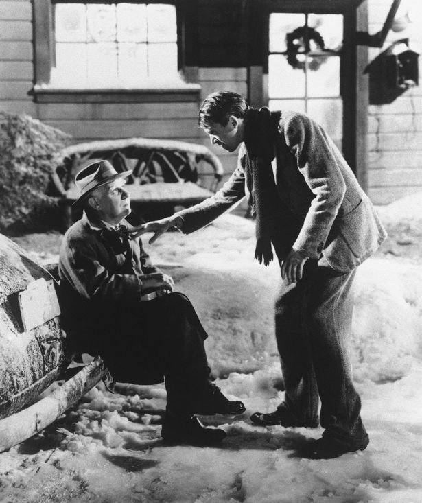 Henry Travers as Clarence the Angel, left, and James Stewart as George Bailey are seen in a scene from It's a Wonderful Life.
