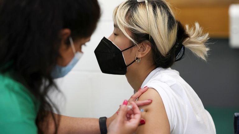 A person receives a dose of the Pfizer BioNTech vaccine at a vaccination center for people over the age of 18 at Belmont Health Center in Harrow, amid the coronavirus disease (COVID-19) outbreak in London, Great Brittany, June 6, 2021