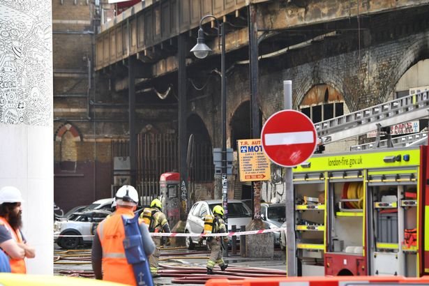 Emergency services at the scene of a fire the TR Autos garage housed in a railway arch near Elephant and Castle station in London.
