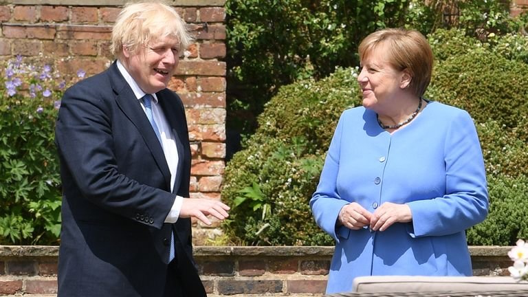 Prime Minister Boris Johnson and German Chancellor Angela Merkel stroll through Checkers Garden, the UK Prime Minister's country home in Buckinghamshire.  Photo date: Friday, July 2, 2021.