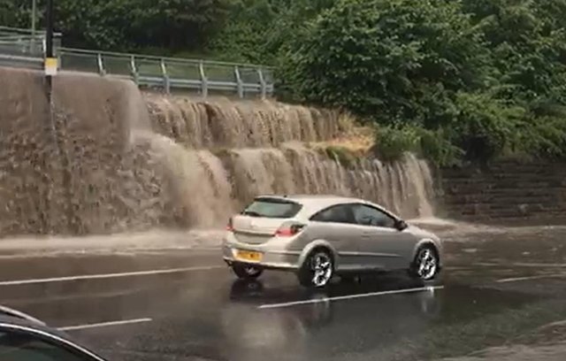 Dramatic footage taken by Ian Parkinson shows rainwater dripping from a nearby parking lot and onto Chesterfield Road.