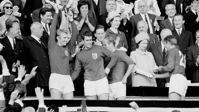 English heroes of the 1966 World Cup celebrate with the trophy after it is presented to them by the Queen
