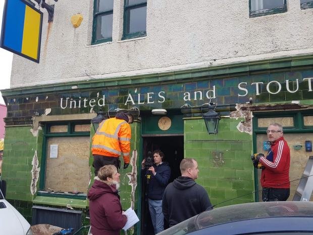 The Argus: workers hack tiles from the Montreal Arms in Brighton 