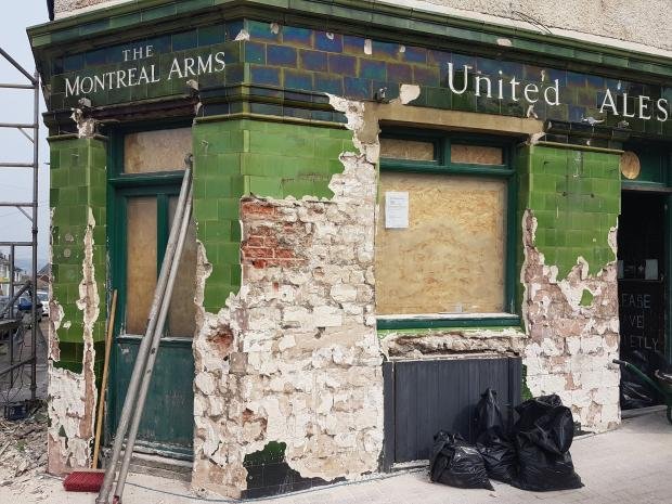 The Argus: workers hack tiles from the Montreal Arms in Brighton 