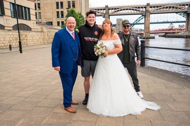 Nige White and Michelle Turnbell with the script, who walked along the quay as they had their wedding photos taken