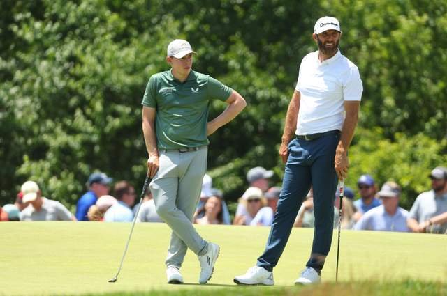 WAITING GAME: Sheffield's Matt Fitzpatrick and USA's Dustin Johnson wait on the seventh green at the US Open Brookline Picture: Andrew Redington/Getty Images