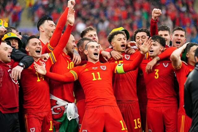 Wales' Gareth Bale (centre) celebrates with his team-mates and staff after qualifying for the Qatar World Cup following victory in the 2022 FIFA World Cup Qualifying Play-off Final match at Cardiff City Stadium over Ukraine.  Image: David Davies/PA Wire.