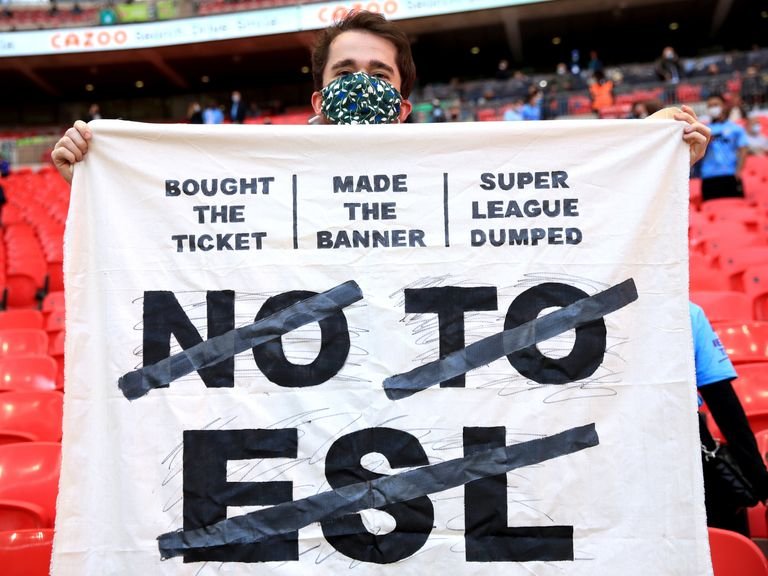 A fan in the stands holds up a banner protesting against the European Super League ahead of the Carabao Cup Final at Wembley Stadium, London. Picture date: Sunday April 25, 2021.